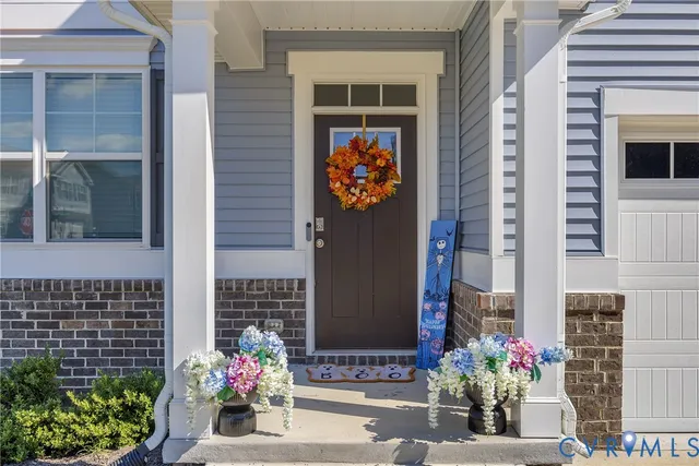 a front view of a house with a flower garden