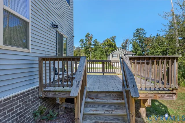 a view of balcony with wooden floor and outdoor seating