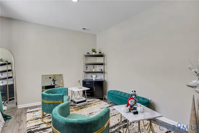 a work room with furniture and wooden floor