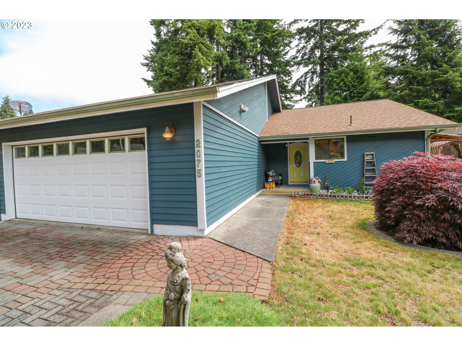 2075 Timberline Drive Coos Bay, OR 97420 - Photo 1 of 39 a view front of house with yard and trees in the background