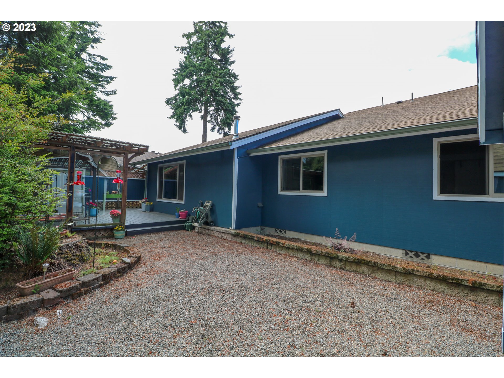 2075 Timberline Drive Coos Bay, OR 97420 - Photo 13 of 39 a backyard of a house with barbeque oven table and chairs