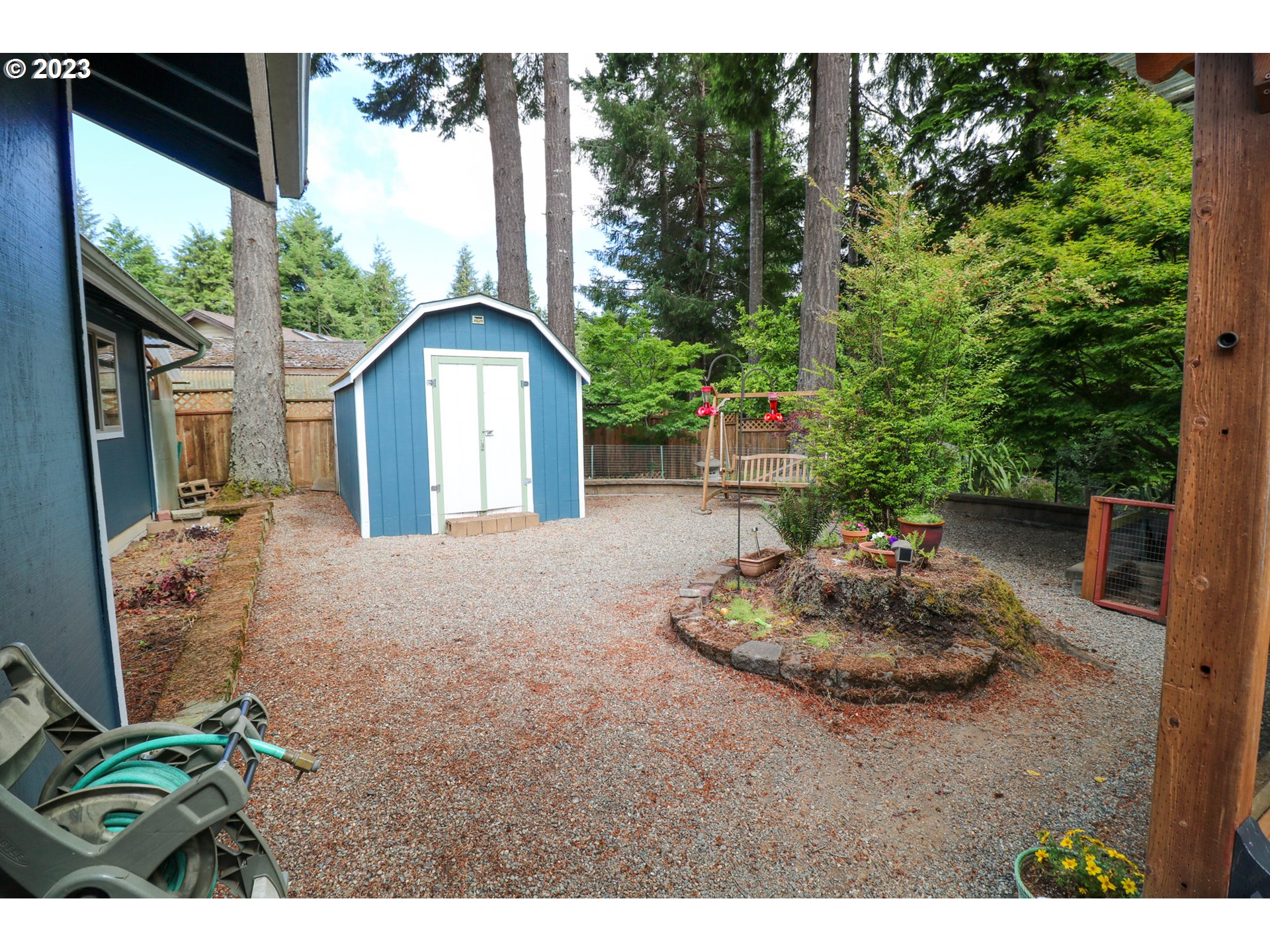 2075 Timberline Drive Coos Bay, OR 97420 - Photo 14 of 39 a backyard of a house with a fountain and a garden