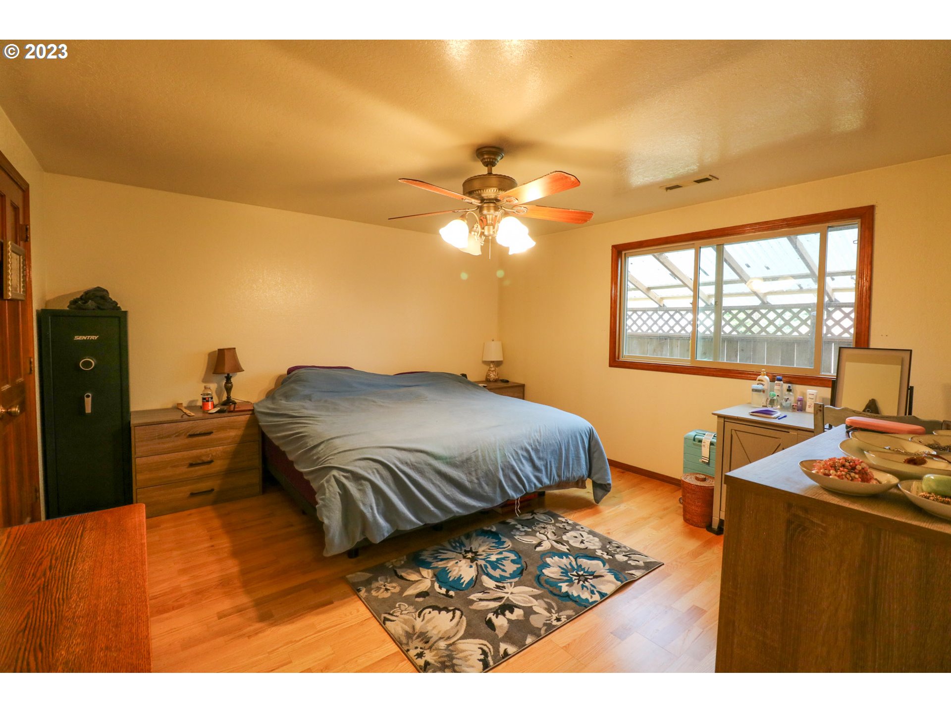 2075 Timberline Drive Coos Bay, OR 97420 - Photo 29 of 39 a bedroom with a bed and a chandelier