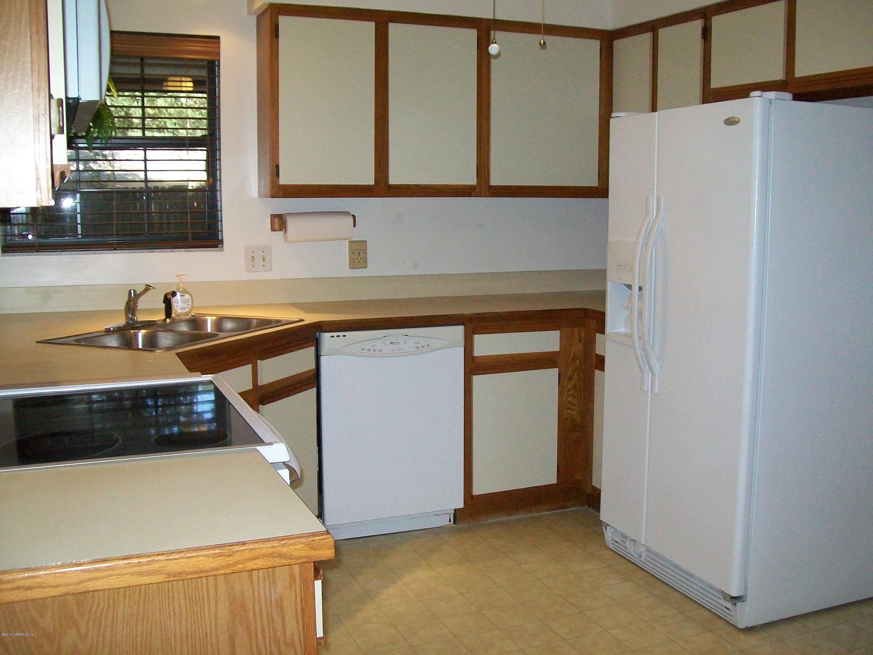 134 Dory Road St. Augustine, FL 32086 - Photo 13 of 25 a kitchen with a sink and a refrigerator