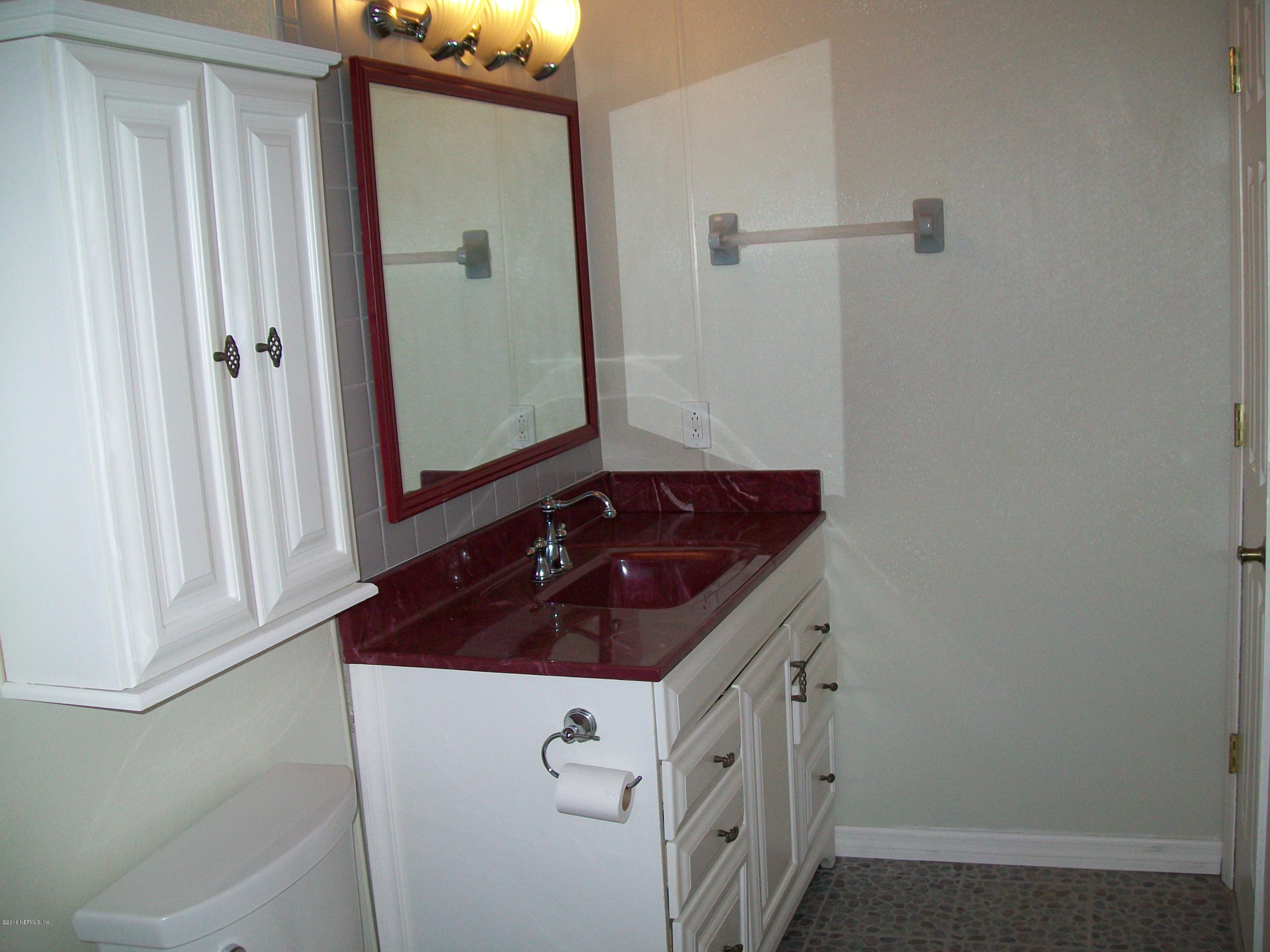 134 Dory Road St. Augustine, FL 32086 - Photo 16 of 25 a bathroom with a sink and a mirror