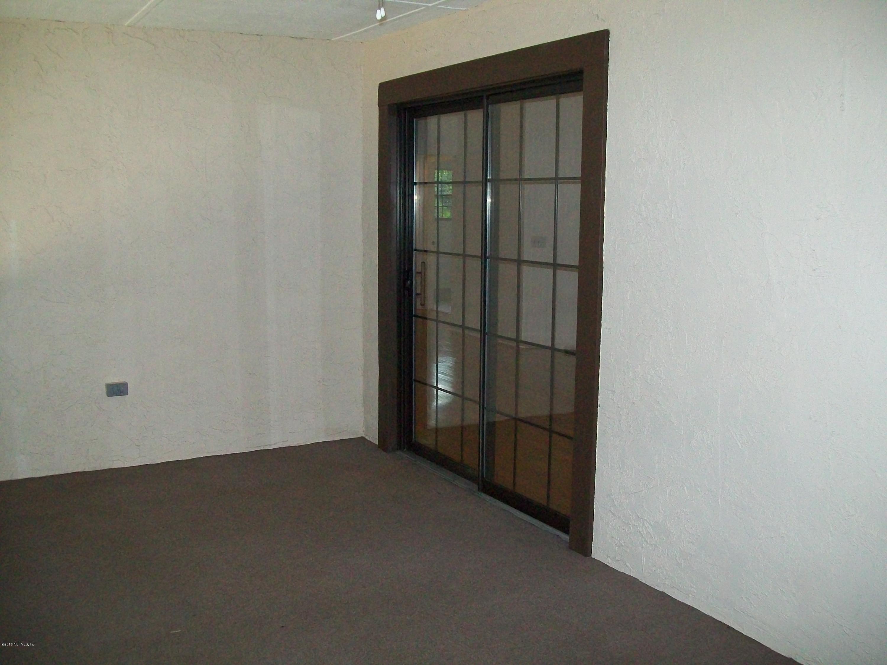 134 Dory Road St. Augustine, FL 32086 - Photo 21 of 25 an empty room with a wooden door