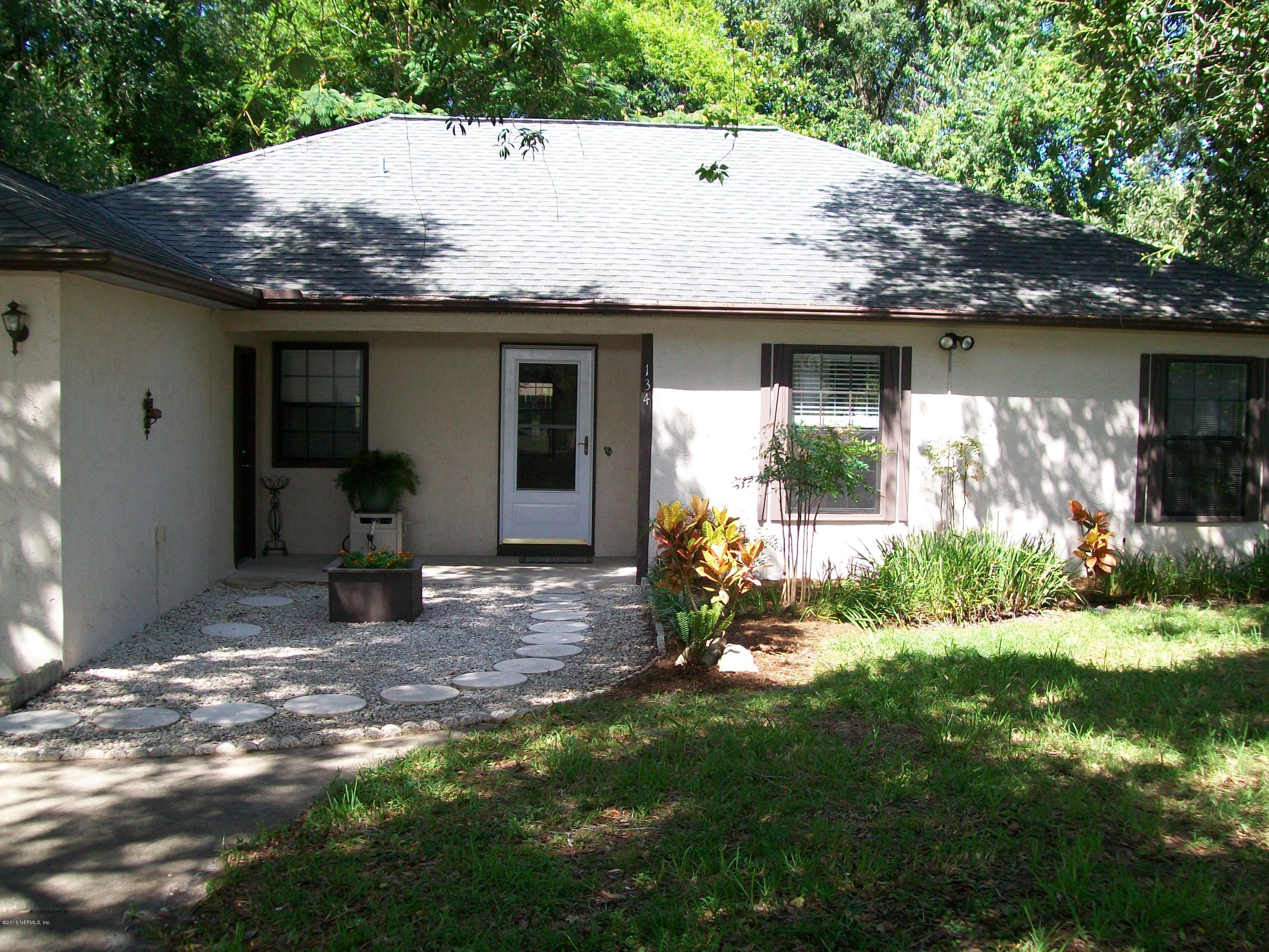 134 Dory Road St. Augustine, FL 32086 - Photo 3 of 25 a view of a house with a yard plants and a large tree