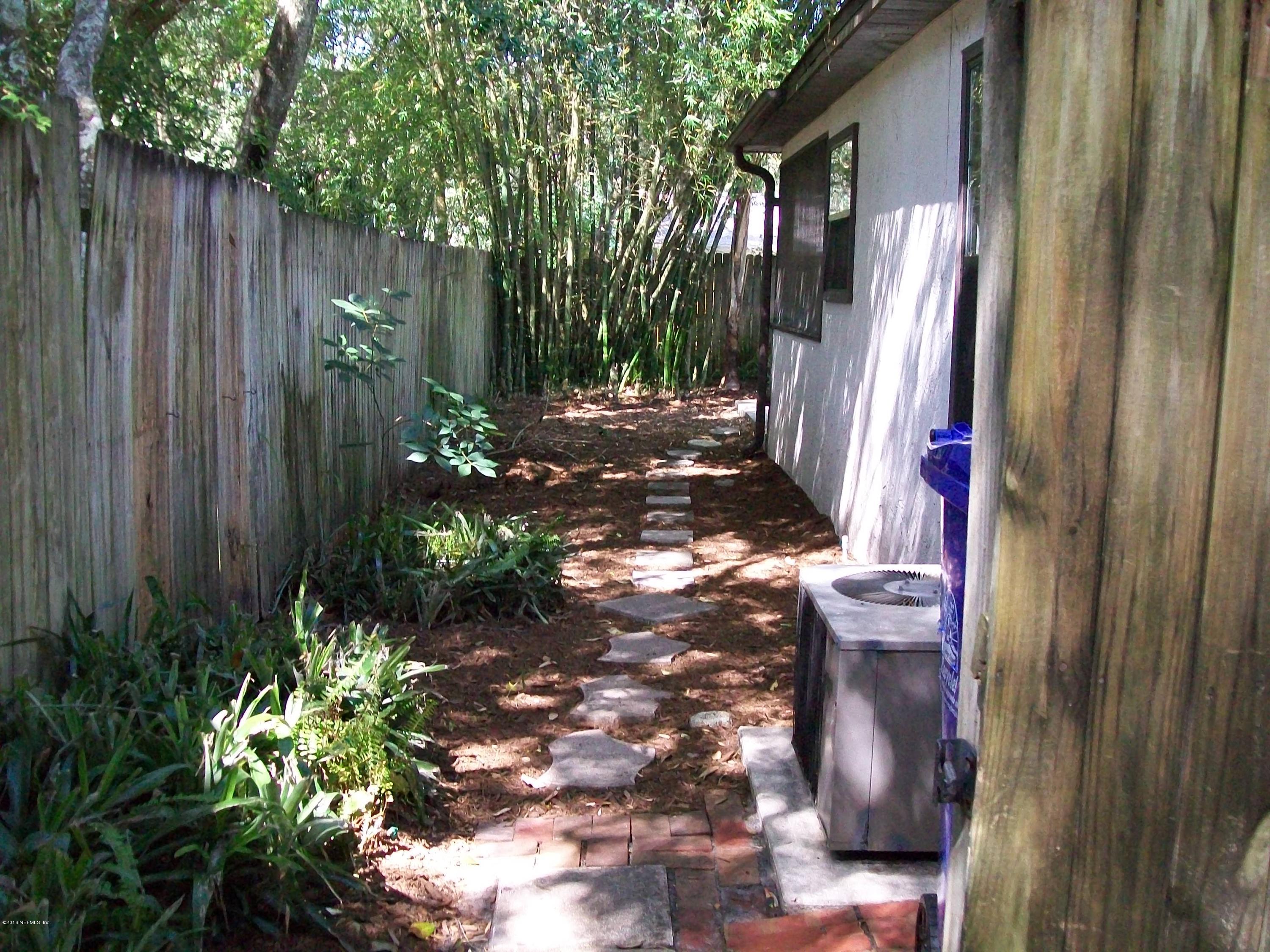 134 Dory Road St. Augustine, FL 32086 - Photo 4 of 25 a view of backyard with table and chairs and wooden fence