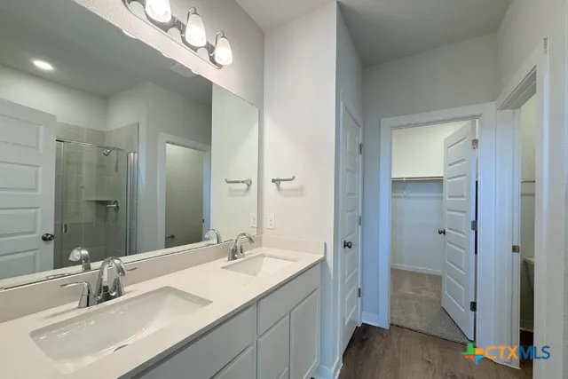 a bathroom with a sink double vanity and shower