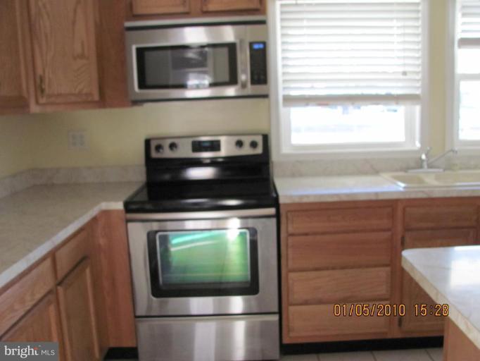 7609 Bull Run Road Manassas, VA 20111 - Photo 5 of 15 a kitchen with a stove and a microwave