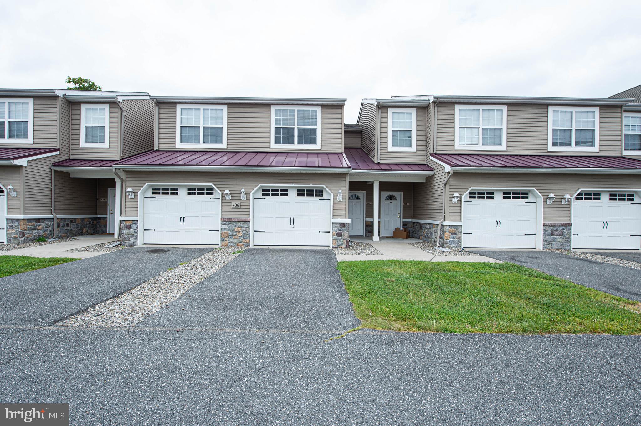 438 Parkview Court, Unit E Salisbury, MD 21804 - Photo 1 of 95 a front view of a house with a garden and parking