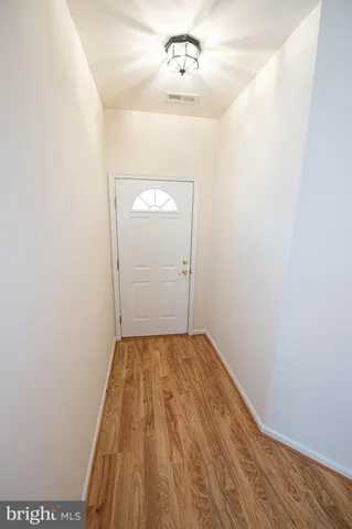 a view of hallway with wooden floor