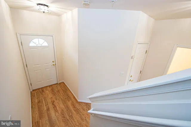 a view of a room with wooden floor and a window