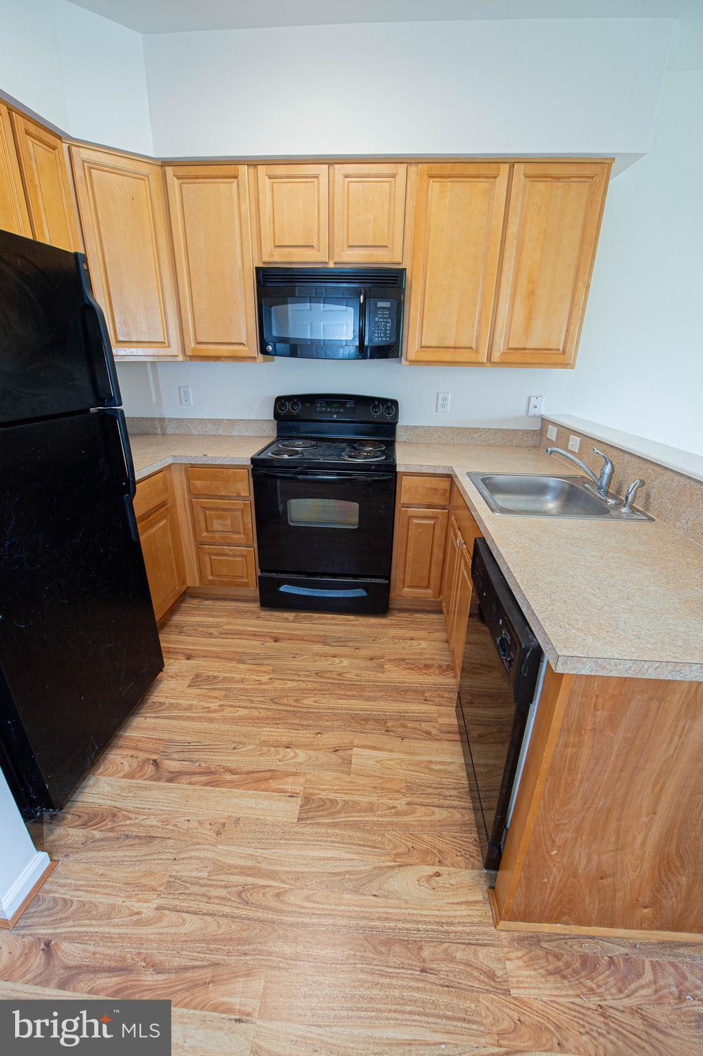438 Parkview Court, Unit E Salisbury, MD 21804 - Photo 28 of 95 a kitchen with granite countertop a stove a sink and a microwave