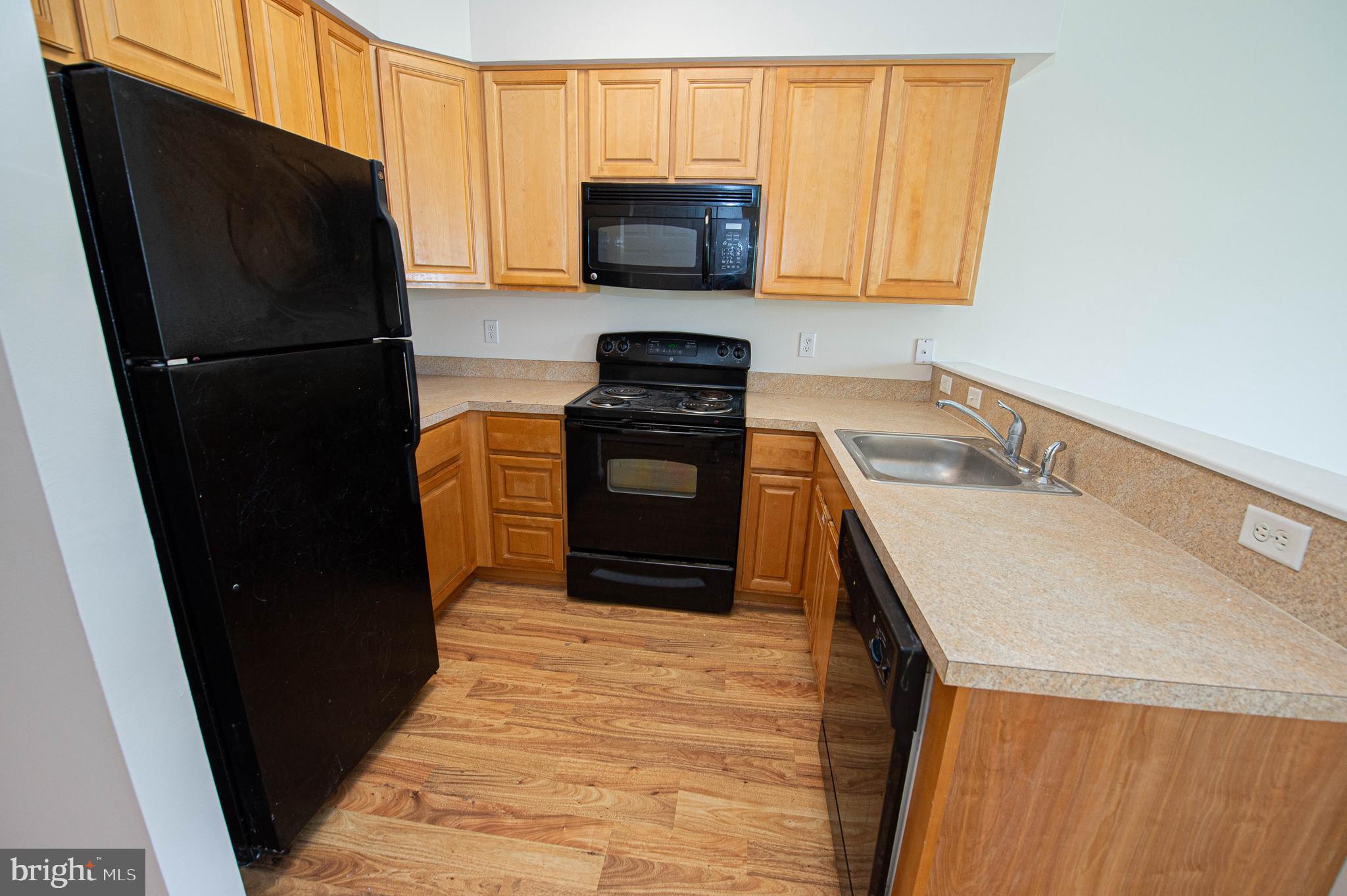 438 Parkview Court, Unit E Salisbury, MD 21804 - Photo 29 of 95 a kitchen with a refrigerator and a stove