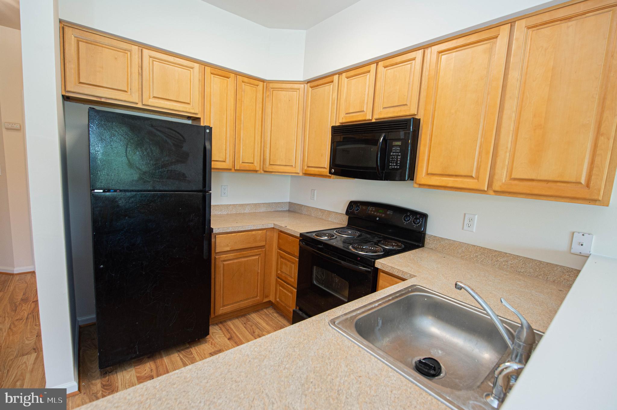 438 Parkview Court, Unit E Salisbury, MD 21804 - Photo 31 of 95 a kitchen with a sink and a stove top oven