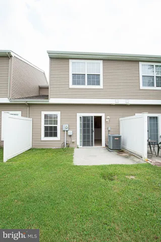 an empty room with windows and ceiling fan