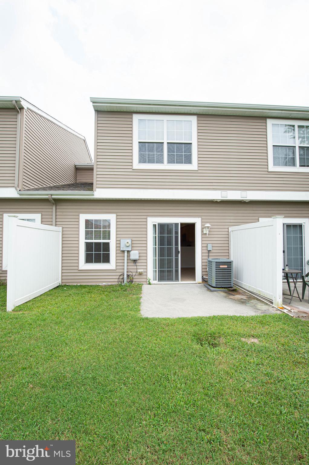 438 Parkview Court, Unit E Salisbury, MD 21804 - Photo 46 of 95 a front view of a house with a yard and trees
