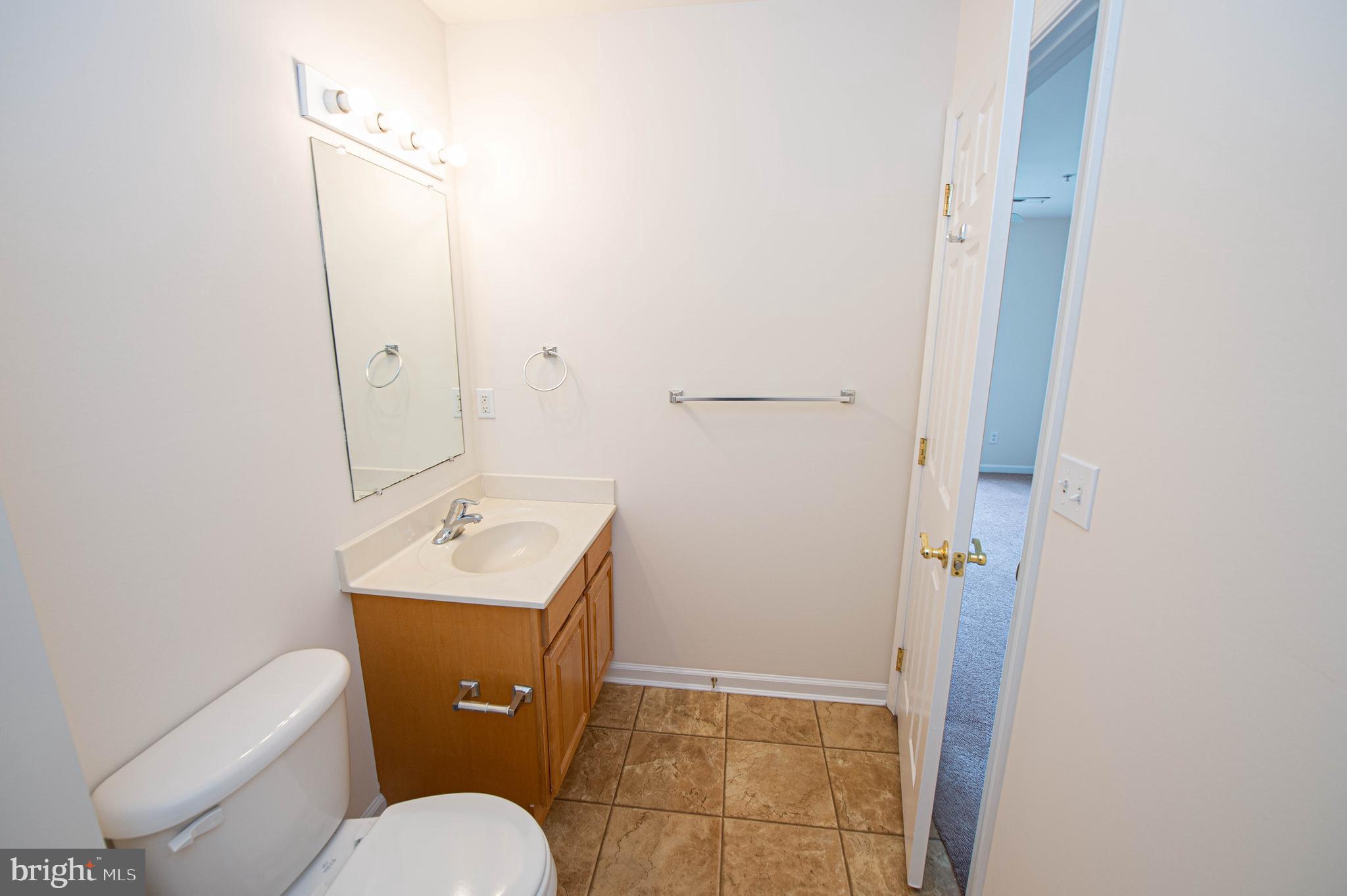 438 Parkview Court, Unit E Salisbury, MD 21804 - Photo 76 of 95 a bathroom with a toilet sink and mirror