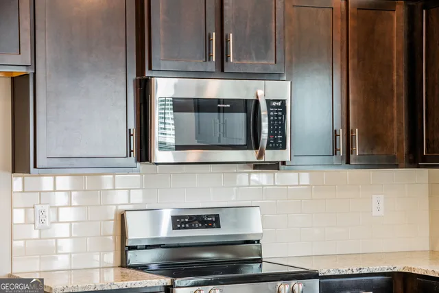 a stove top oven sitting inside of a kitchen