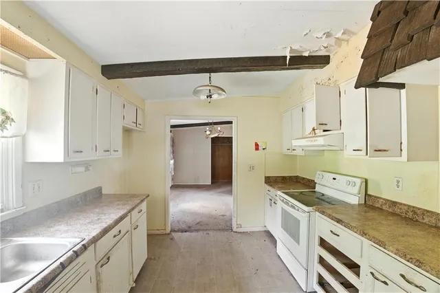 a kitchen with a sink cabinets and window