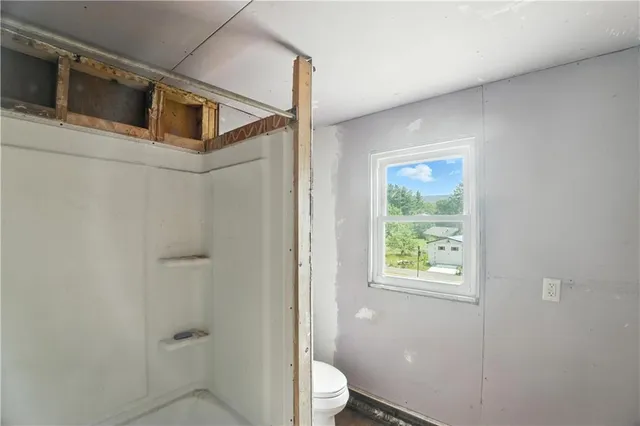 a bathroom with a toilet sink and shower