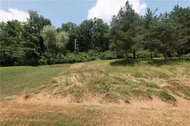 a view of a balcony with wooden floor and lake view