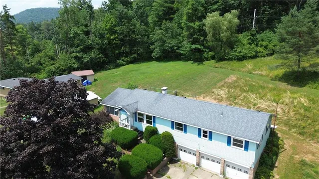 an aerial view of house with yard