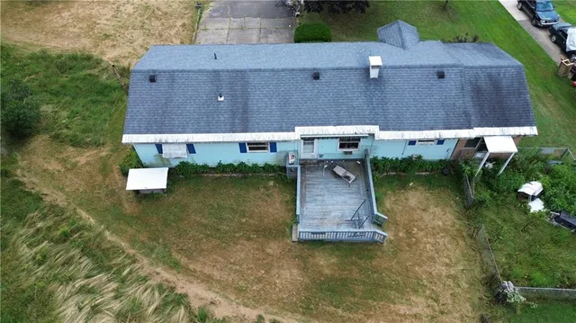 an aerial view of a house with a yard