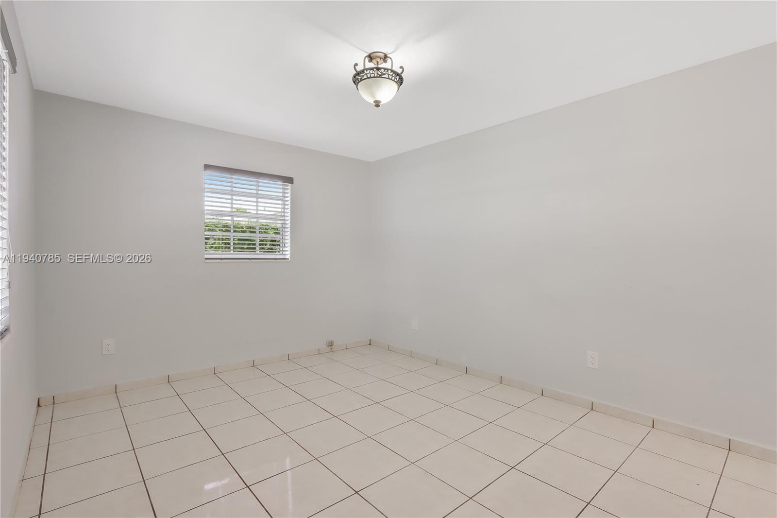 5725 Southwest 107th Place Miami, FL 33173 - Photo 12 of 21 a view of an empty room with a window