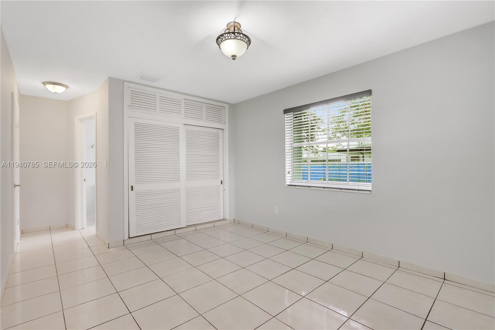 5725 Southwest 107th Place Miami, FL 33173 - Photo 13 of 21 a view of an empty room with a window