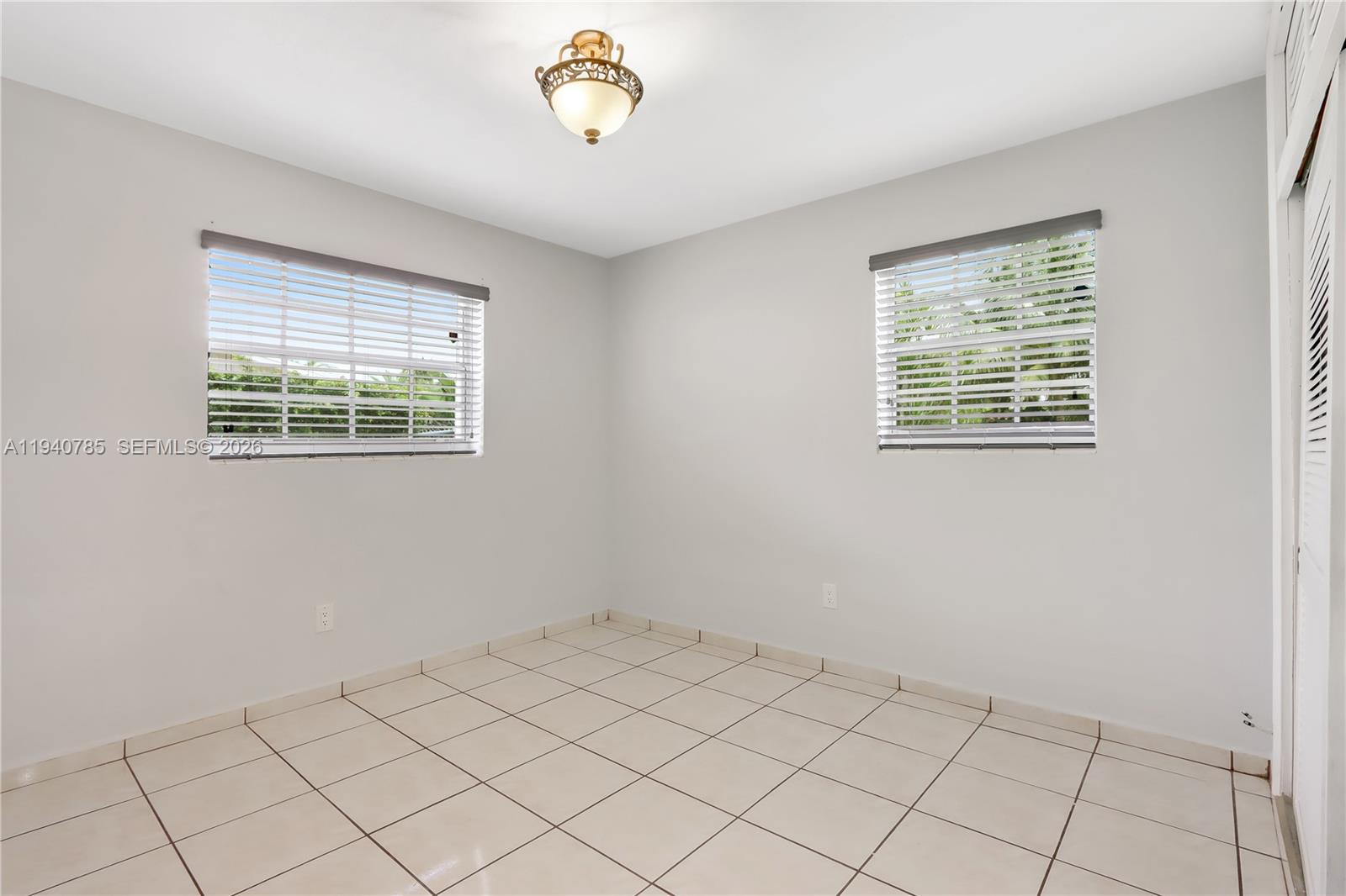 5725 Southwest 107th Place Miami, FL 33173 - Photo 15 of 21 a view of an empty room with a window