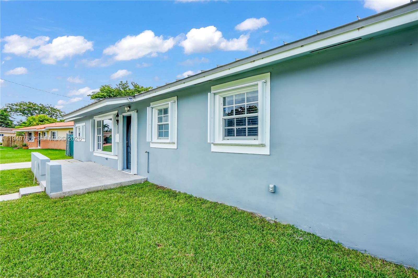5725 Southwest 107th Place Miami, FL 33173 - Photo 2 of 21 a front view of house with yard and green space