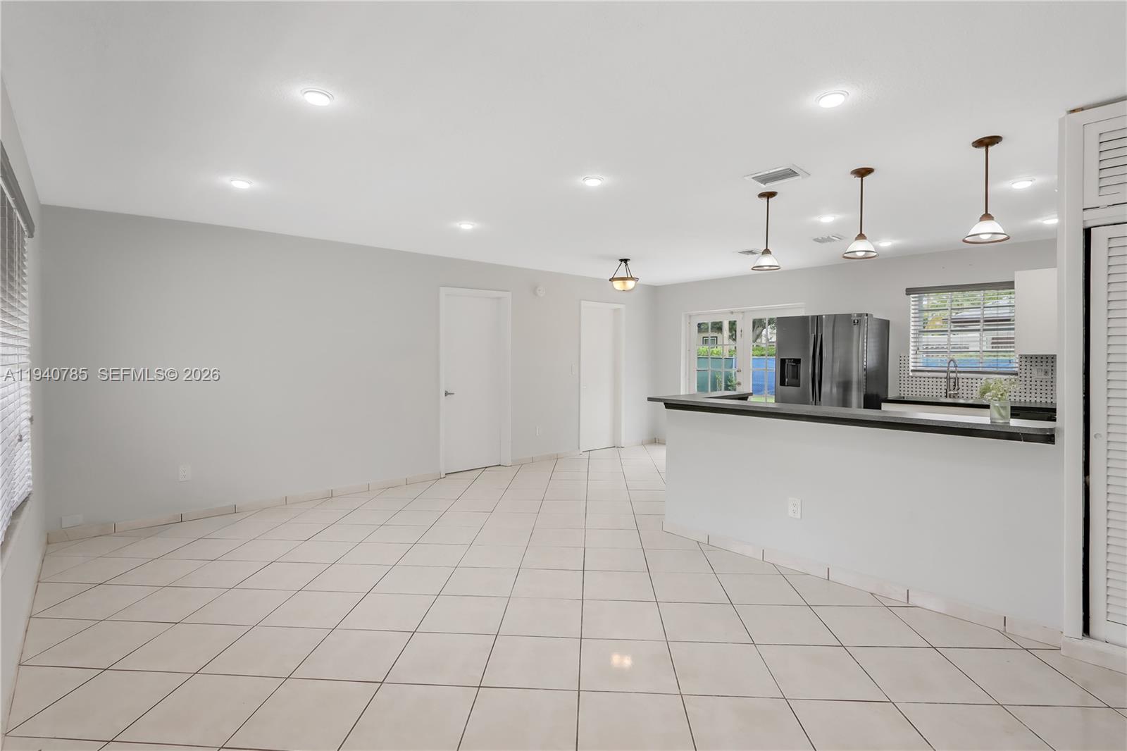 5725 Southwest 107th Place Miami, FL 33173 - Photo 7 of 21 a kitchen with stainless steel appliances granite countertop a refrigerator and a stove top oven
