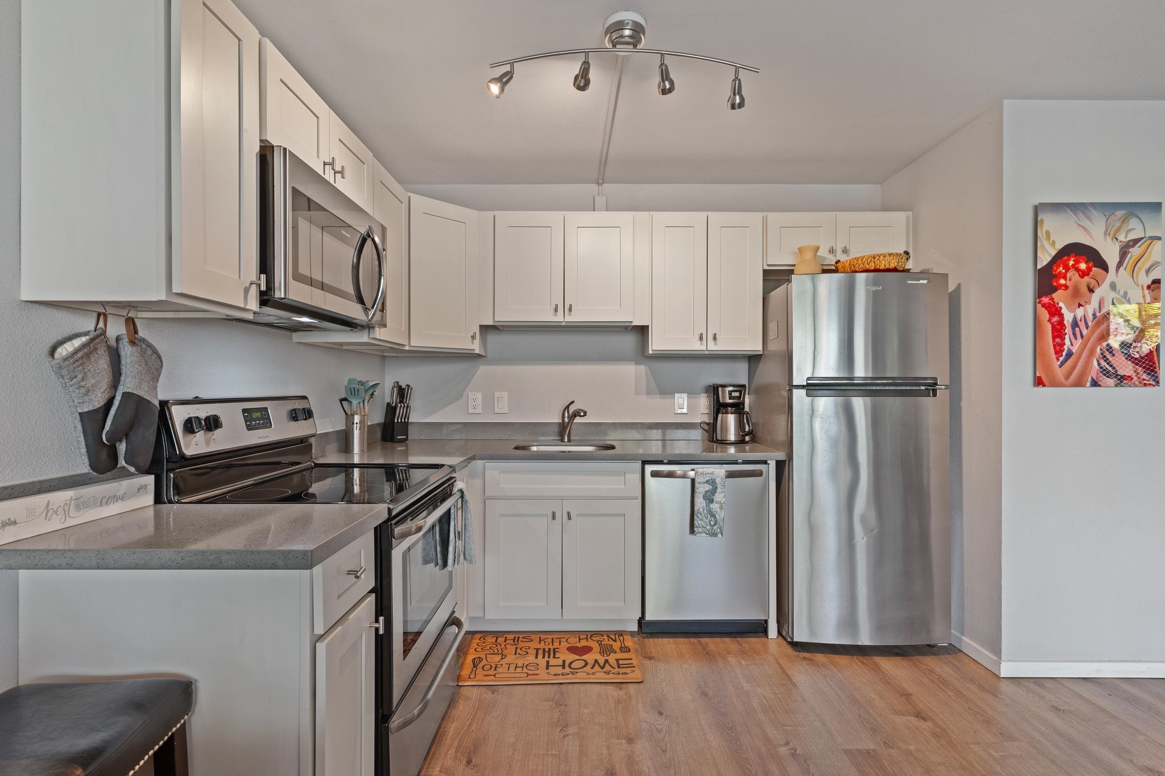 2495 South Kihei Road, Unit 155 Kihei, HI 96753 - Photo 16 of 33 a kitchen with stainless steel appliances granite countertop a refrigerator stove and sink