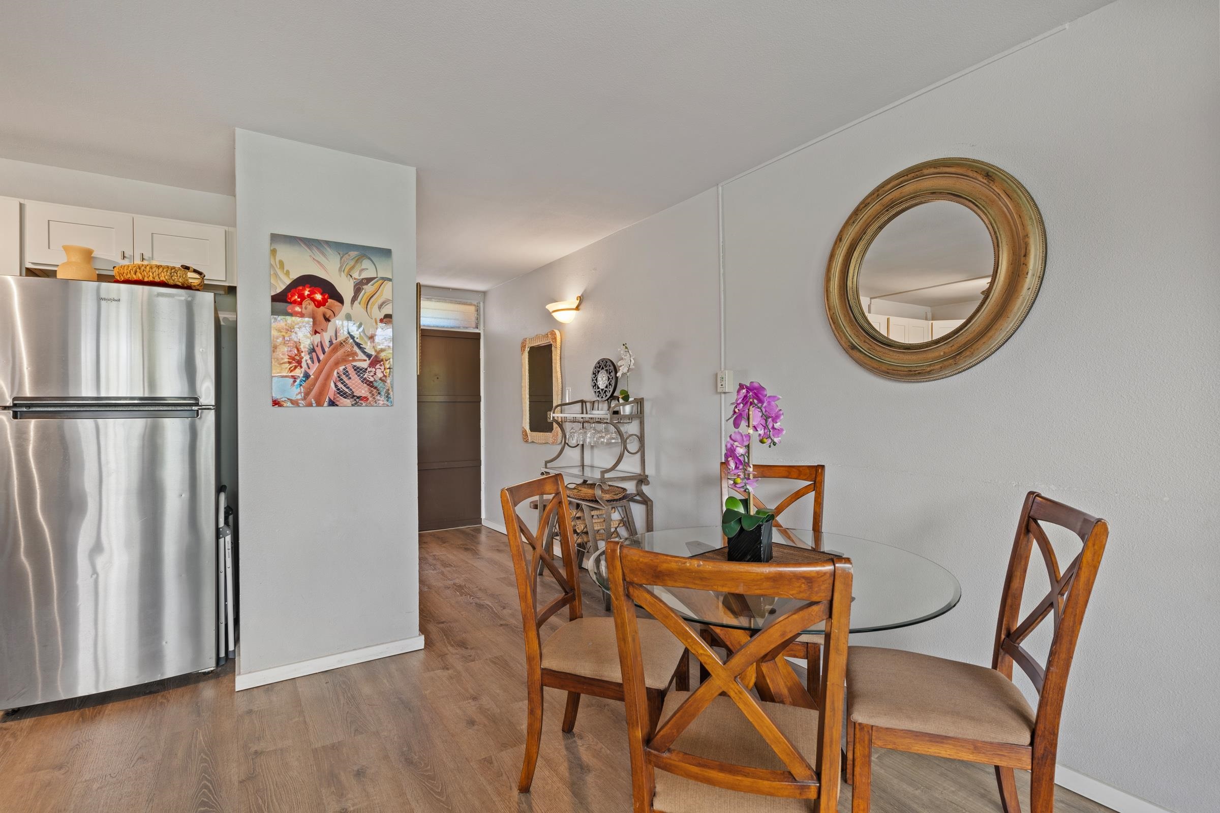 2495 South Kihei Road, Unit 155 Kihei, HI 96753 - Photo 20 of 33 a view of a dining room with furniture and wooden floor