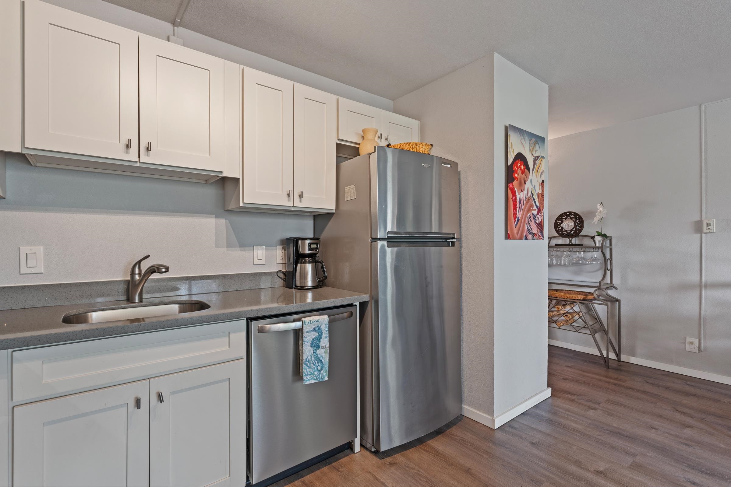 2495 South Kihei Road, Unit 155 Kihei, HI 96753 - Photo 24 of 33 a kitchen with stainless steel appliances granite countertop a refrigerator sink and cabinets