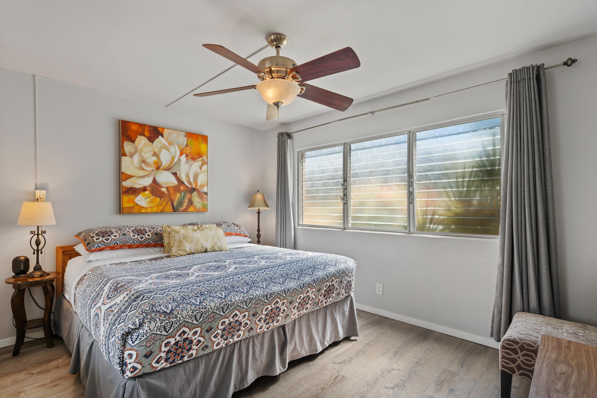 2495 South Kihei Road, Unit 155 Kihei, HI 96753 - Photo 27 of 33 a bedroom with a bed painting on wall and a large window