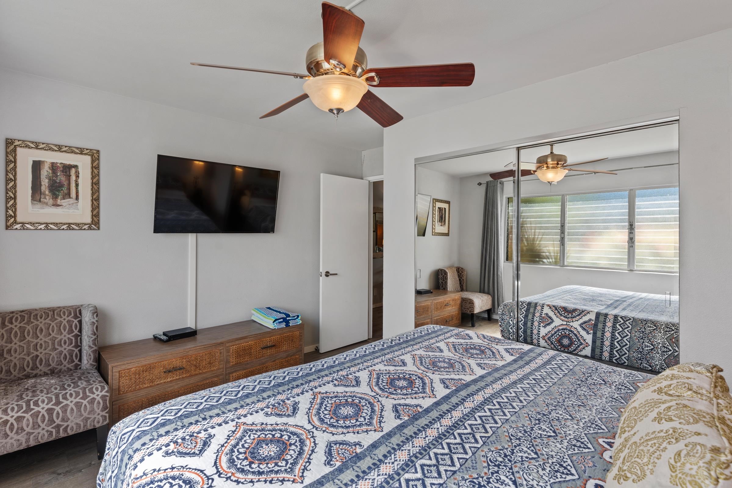 2495 South Kihei Road, Unit 155 Kihei, HI 96753 - Photo 28 of 33 a bedroom with a bed and a flat screen tv