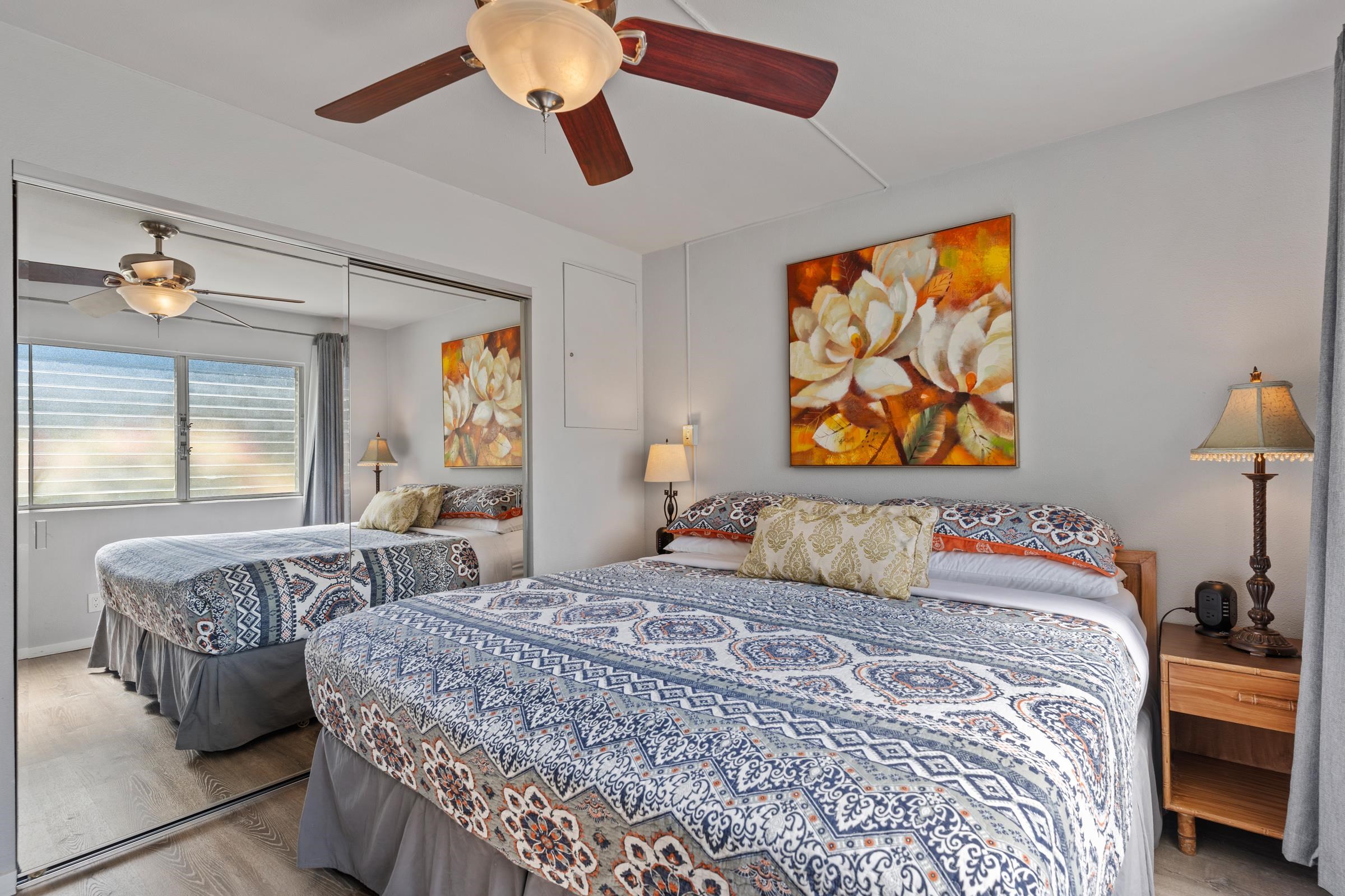 2495 South Kihei Road, Unit 155 Kihei, HI 96753 - Photo 29 of 33 a bedroom with a bed and wooden floor