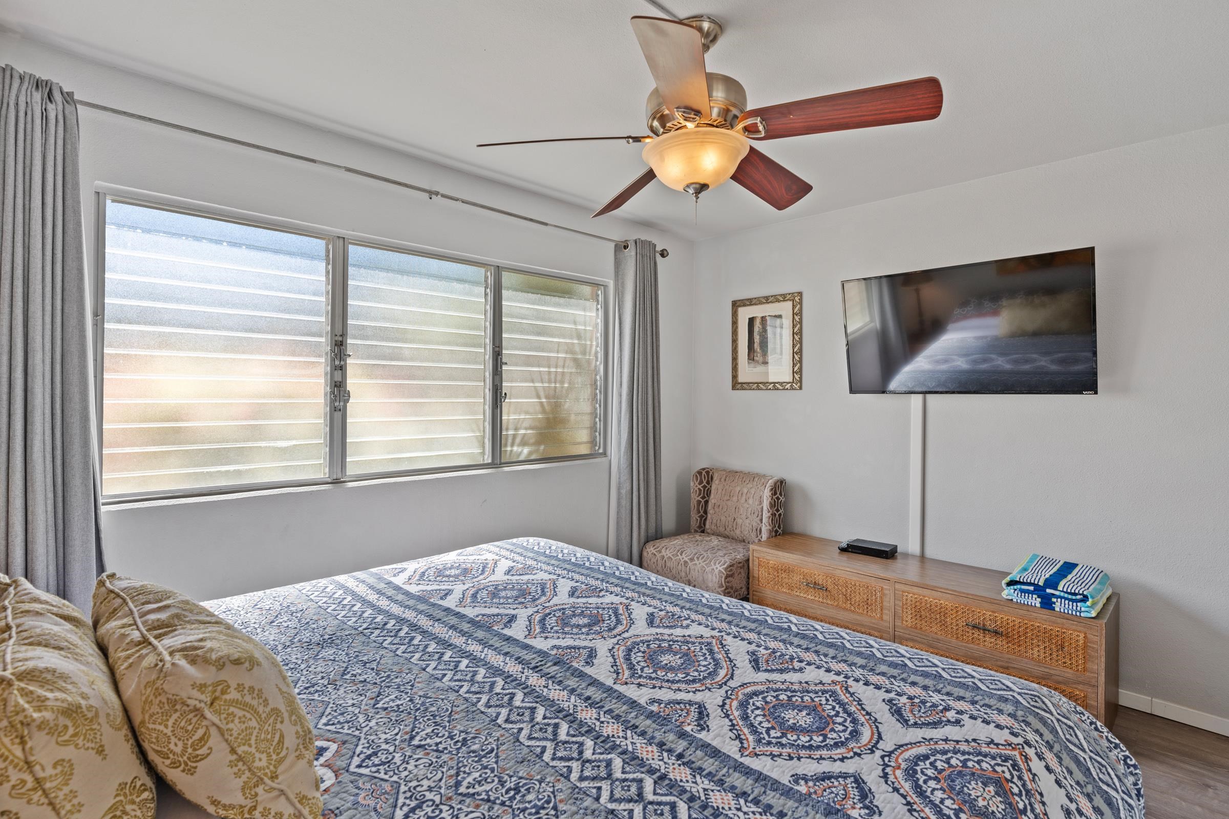 2495 South Kihei Road, Unit 155 Kihei, HI 96753 - Photo 30 of 33 a bedroom with a bed and wooden floor