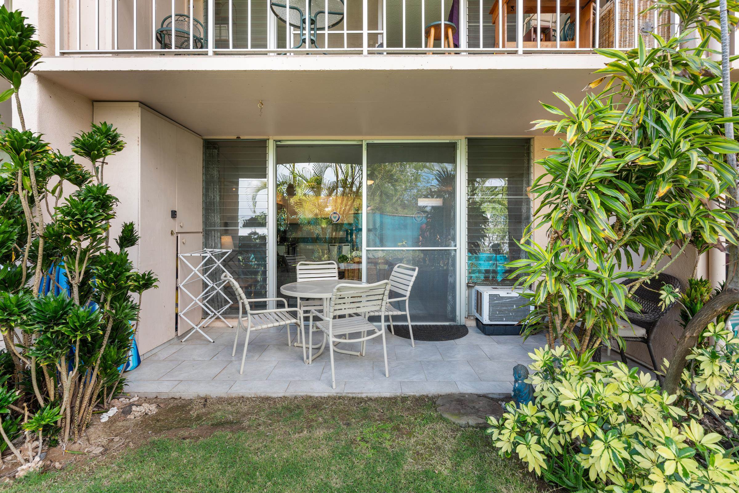 2495 South Kihei Road, Unit 155 Kihei, HI 96753 - Photo 10 of 33 a view of a patio with table and chairs potted plants and floor to ceiling window