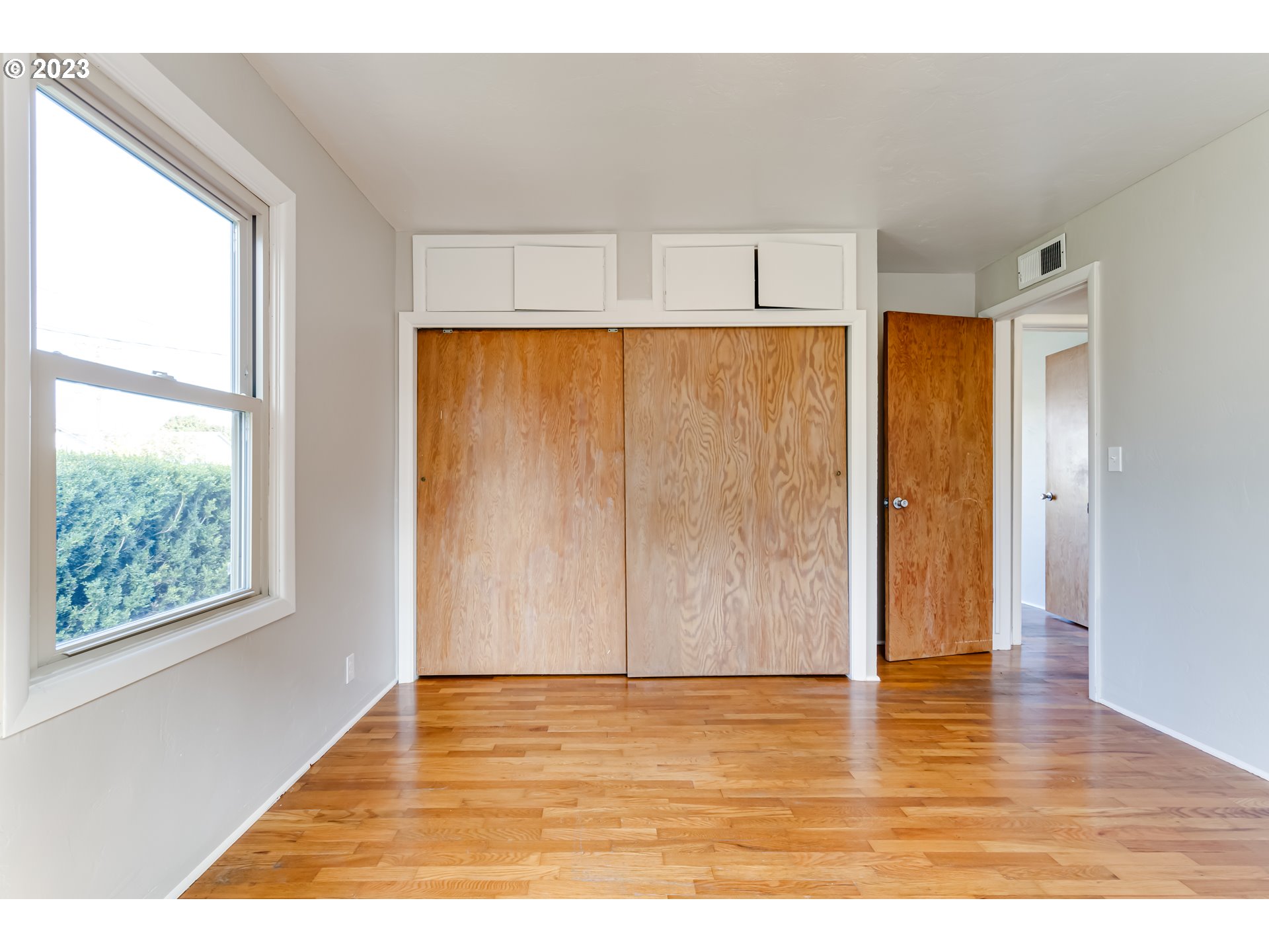 4055 North Street Springfield, OR 97478 - Photo 22 of 48 a view of an empty room with wooden floor and a window