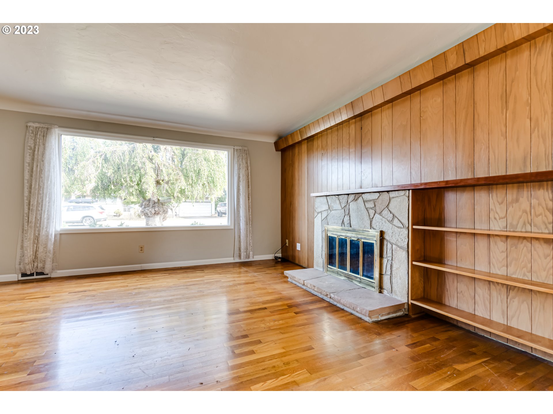 4055 North Street Springfield, OR 97478 - Photo 6 of 48 a view of empty room with wooden floor and fireplace