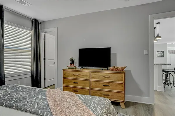 a room with a bed and flat screen tv