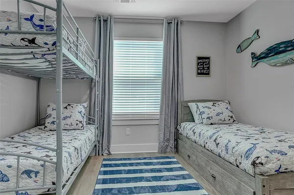 a bedroom with a bed and a mirror