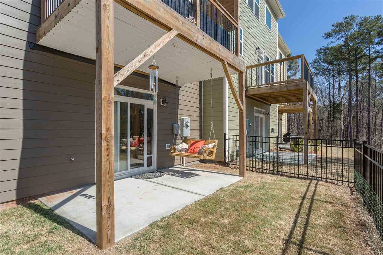 605 Edgewater Ridge Court Apex, NC 27523 - Photo 23 of 25 The patio space features a 'ceiling' under the deck to keep the patio from being drenched when it rains.