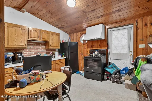 a dining room with furniture a fireplace and wooden floor