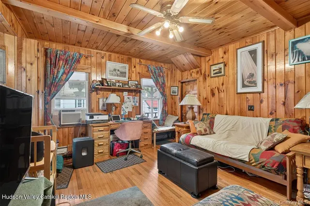 a living room with furniture a fireplace and a chandelier