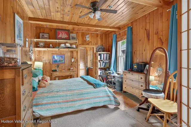 a bedroom with bed and wooden floor